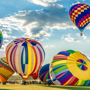 Multiple colorful giant balloons are being blown at the balloons festival