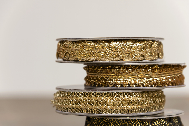 Closeup Stack of Gold ribbon in different with space on the background